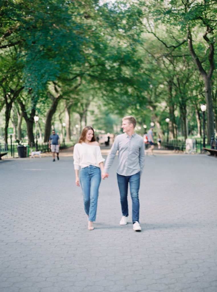 walking towards camera at central park engagement session
