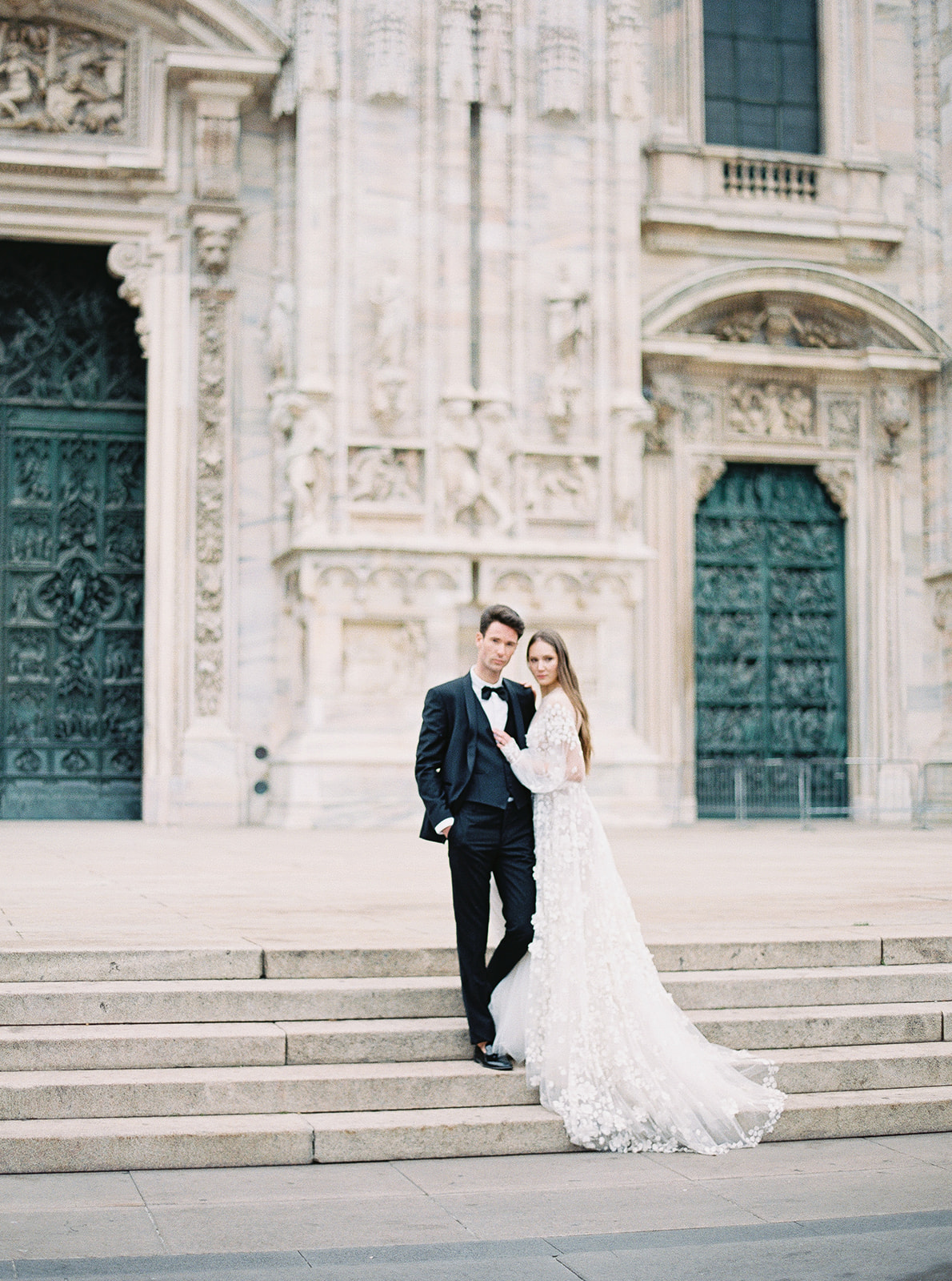 bride and groom in front of the piazza del duomo during a luxury photographer wedding photoshoot
