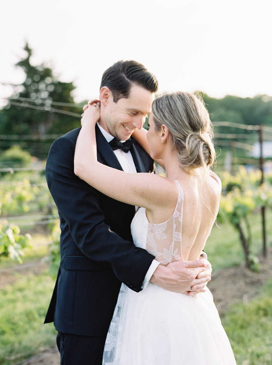 bride and groom forehead to forehead in the vineyard