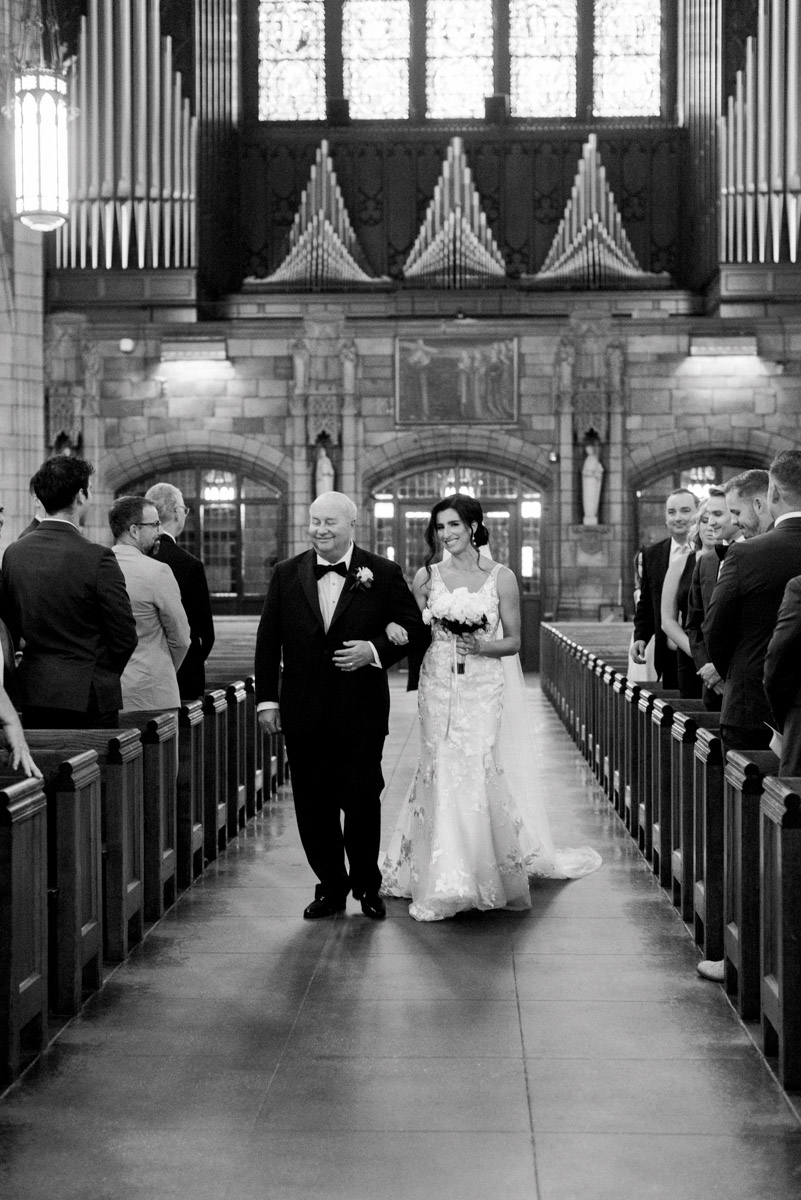 bride coming down aisle with father