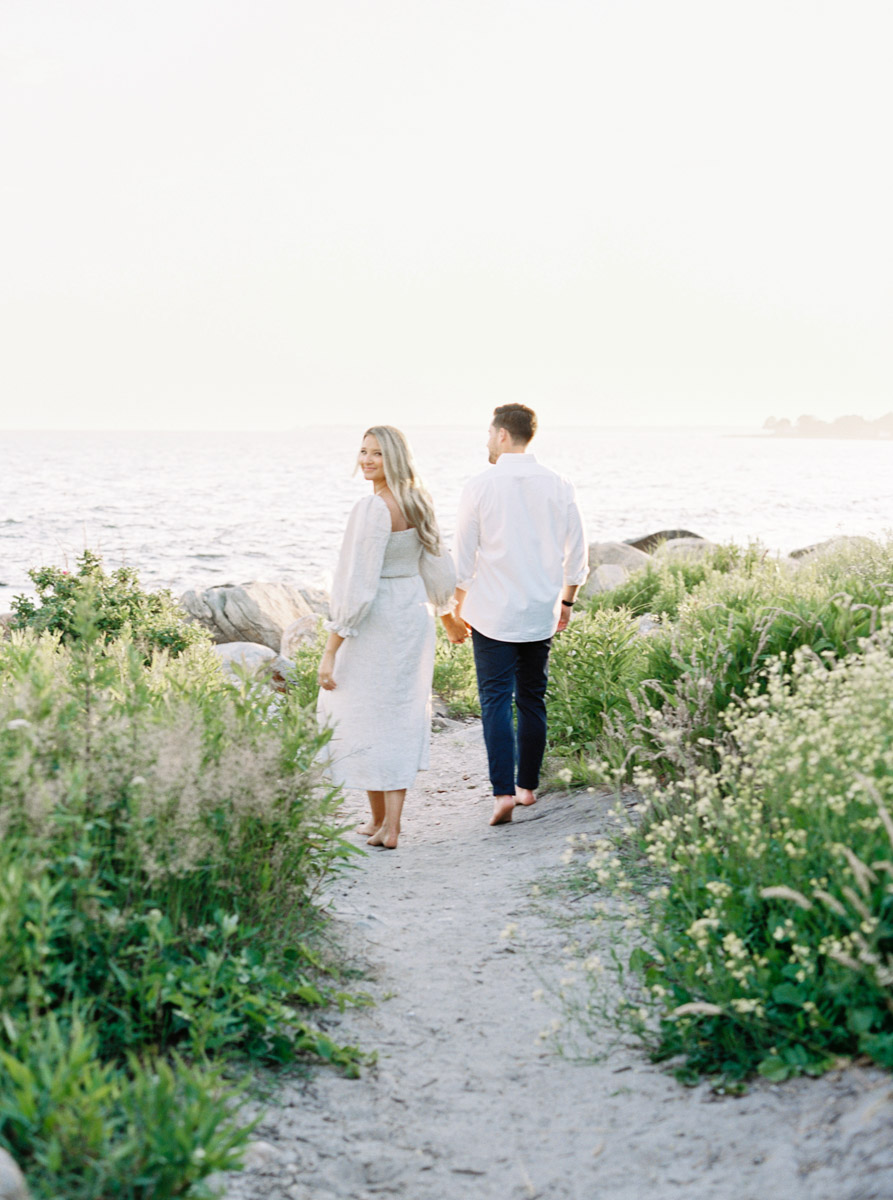 walking along the path on the beach at this Connecticut engagement session