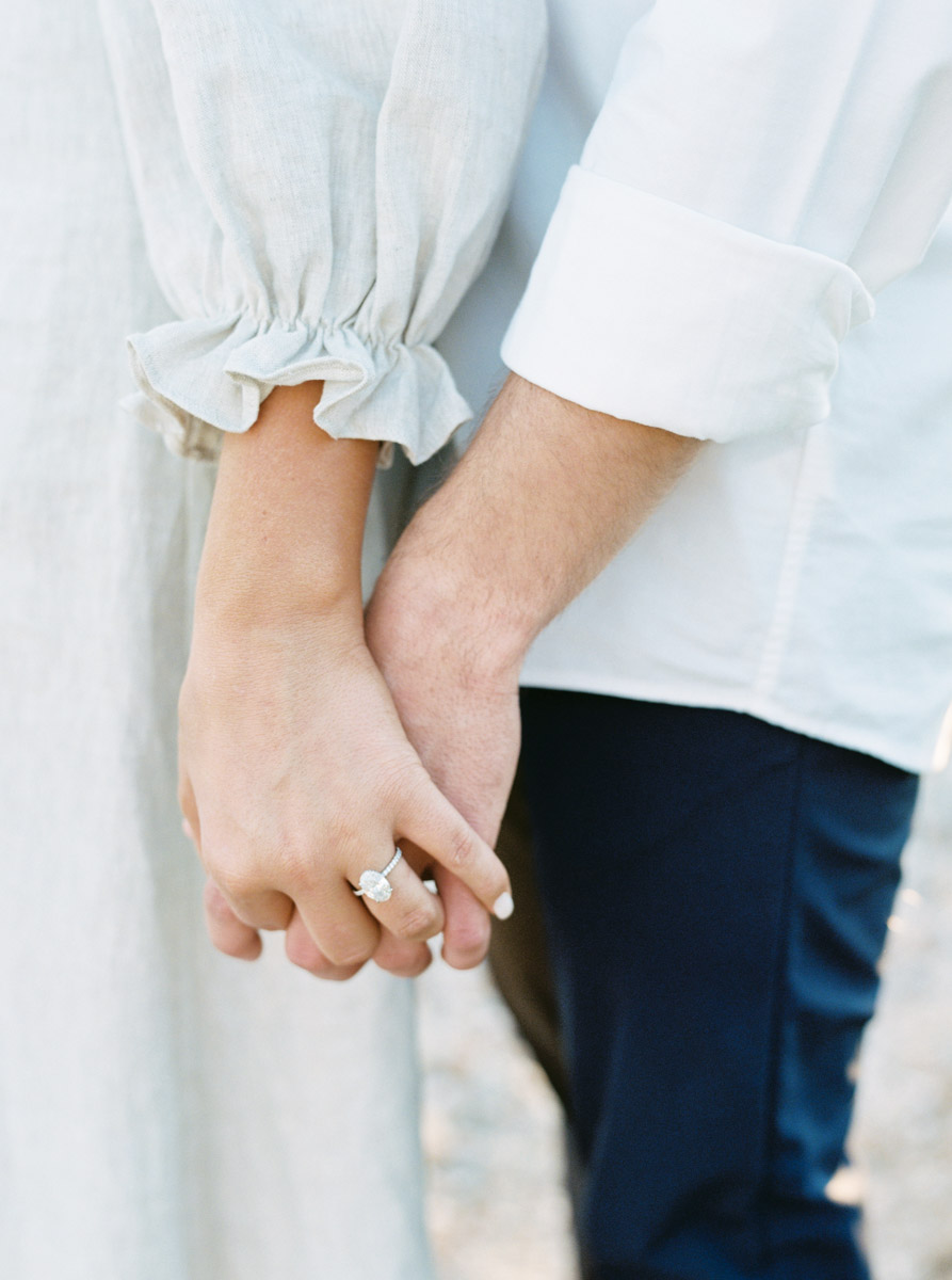 close up of the couple's hands with engagement ring