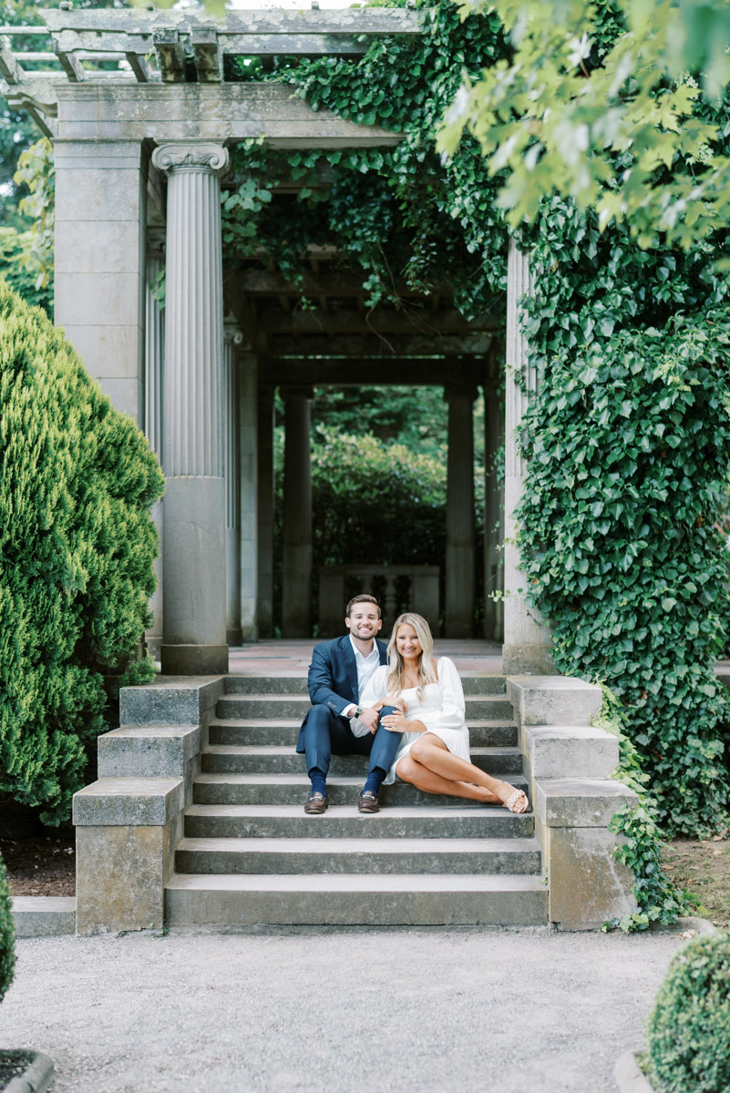 sitting on the steps in the garden at this Connecticut engagement session