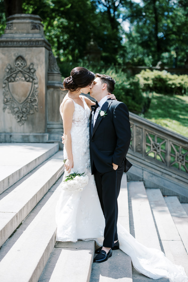 bride and groom kissing on the steps at bethesda terrace