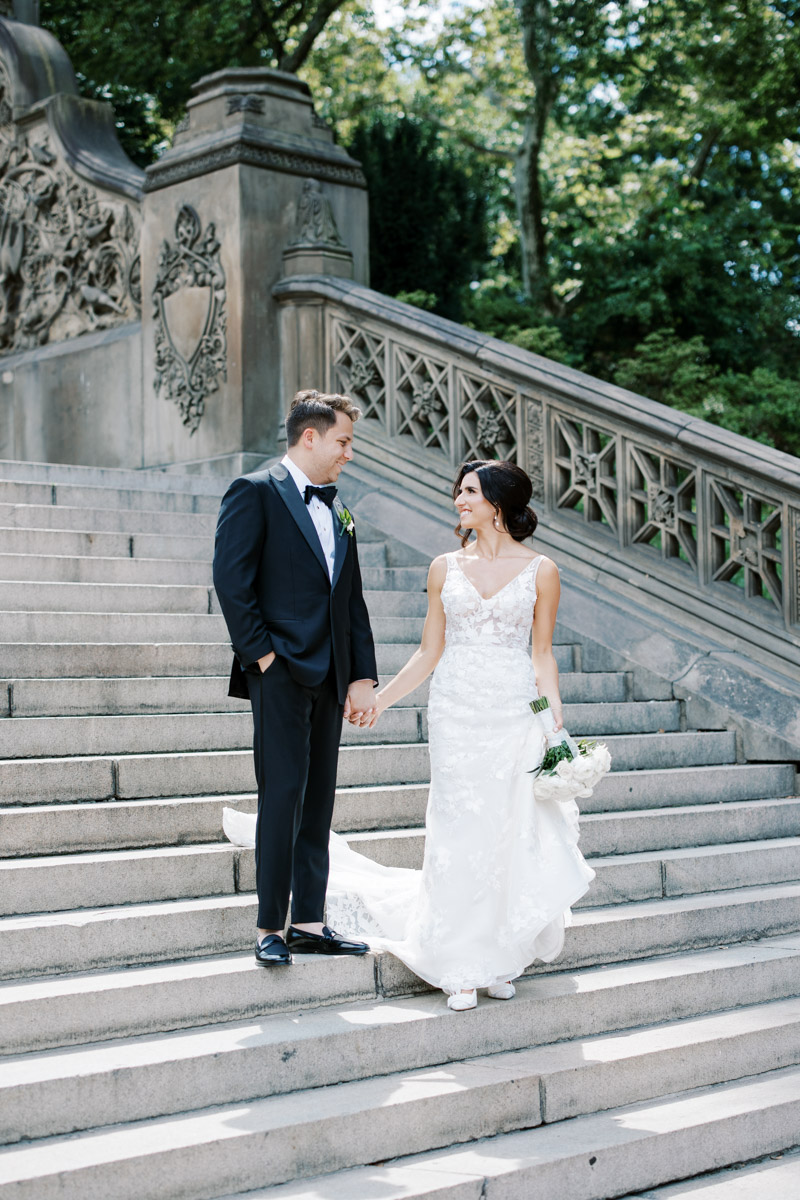 bride and groom looking at each other on stairs of bethesda