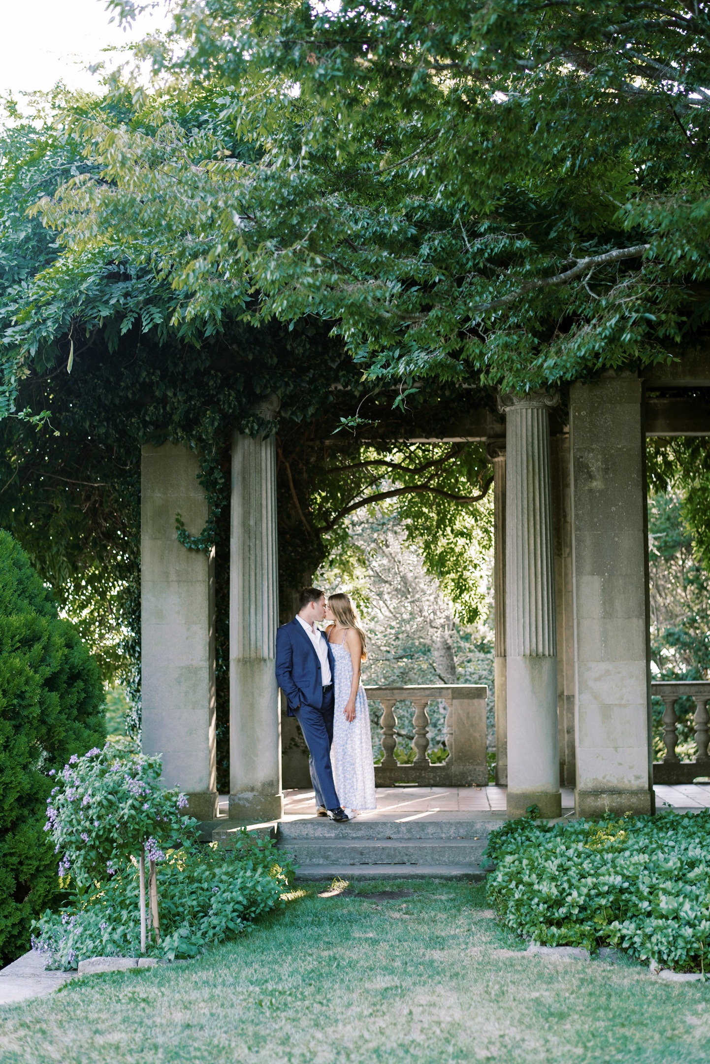 bride and groom kissing under the trellis for ct engagement photographer