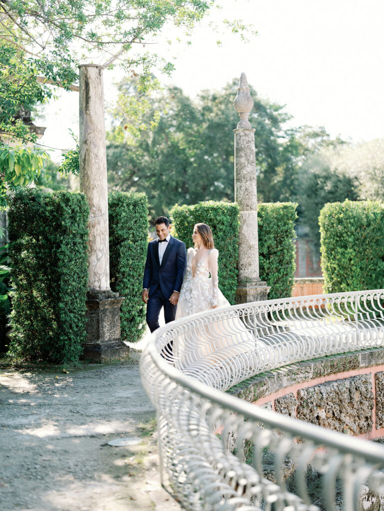 Bride and groom strolling through Vizcaya Museum and Gardens Wedding.