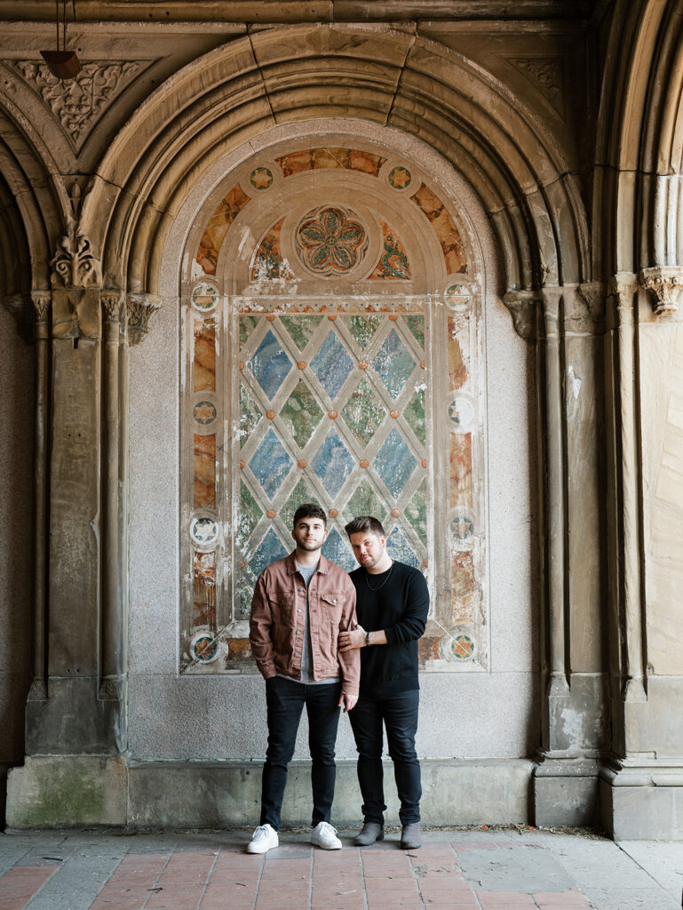 Classic portrait of the couple under Bethesda Terrace with the murals.