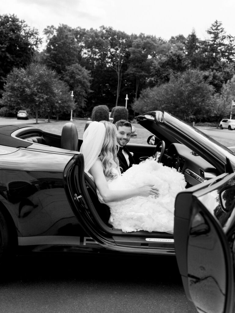bride and groom in their getaway car