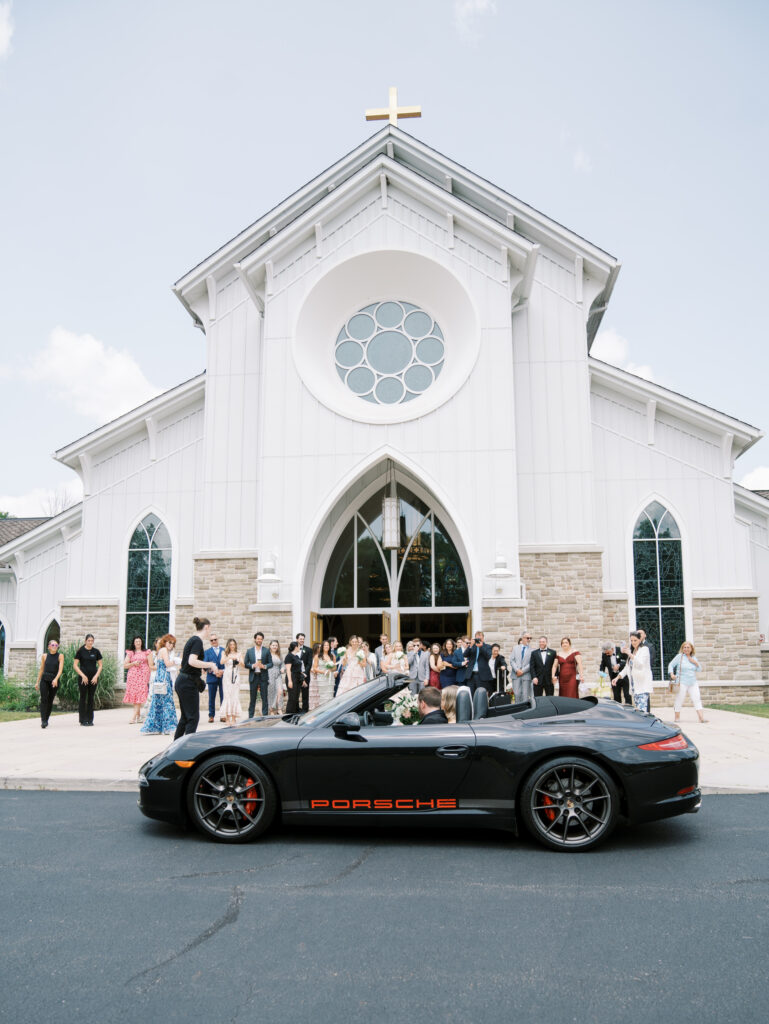 wide view of getaway car in front of church