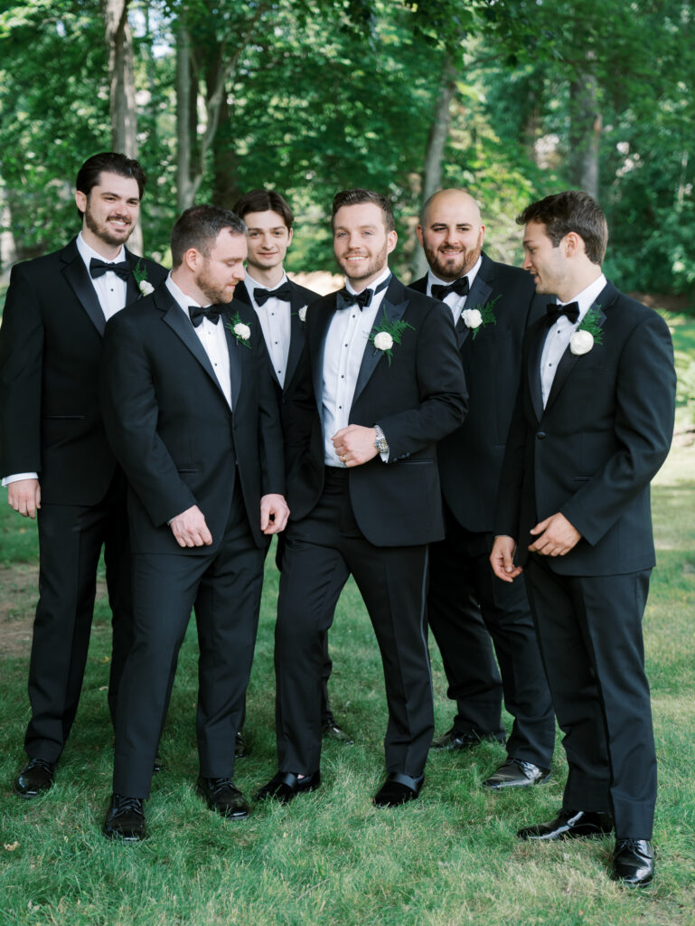 groom with his groomsmen standing for a portrait