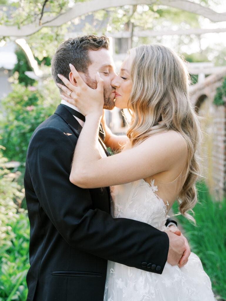 close up of bride and groom kissing at golden hour during their keeler tavern wedding
