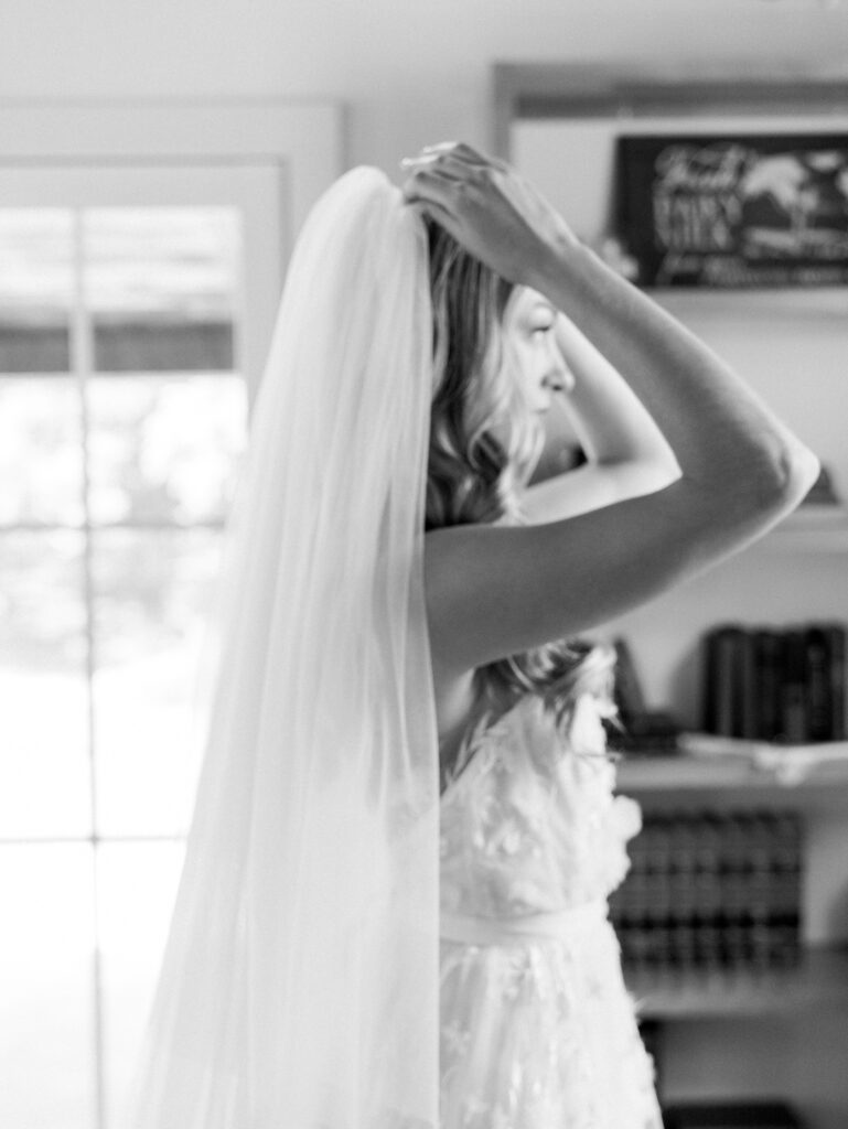 bride putting on veil