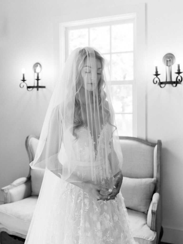 black and white portrait with veil over her face