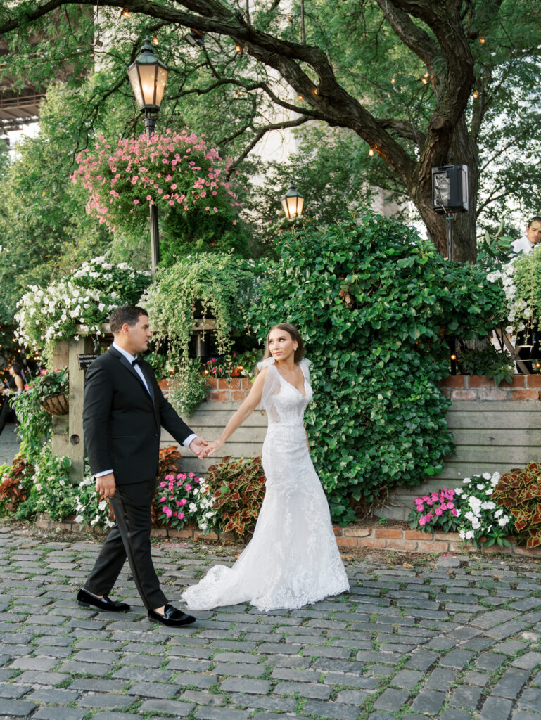 bride and groom walking the cobblestone street of the river cafe