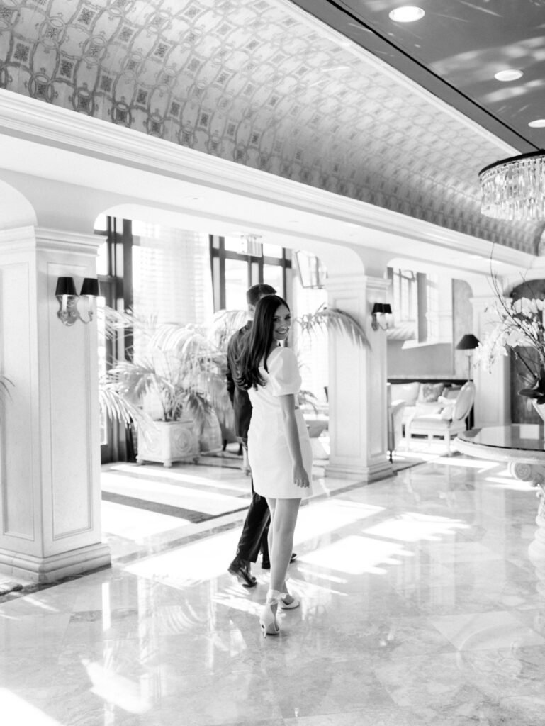 the couple walking together in the hotel lobby during their engagement session
