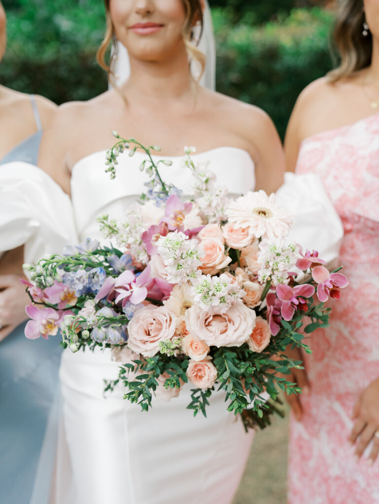 Bridesmaids mid crop of the flowers and texture of the dress when wondering Questions to Ask Your Wedding Photographer.