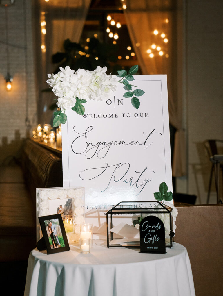 A photograph of the sign that says Welcome to our Engagement Party