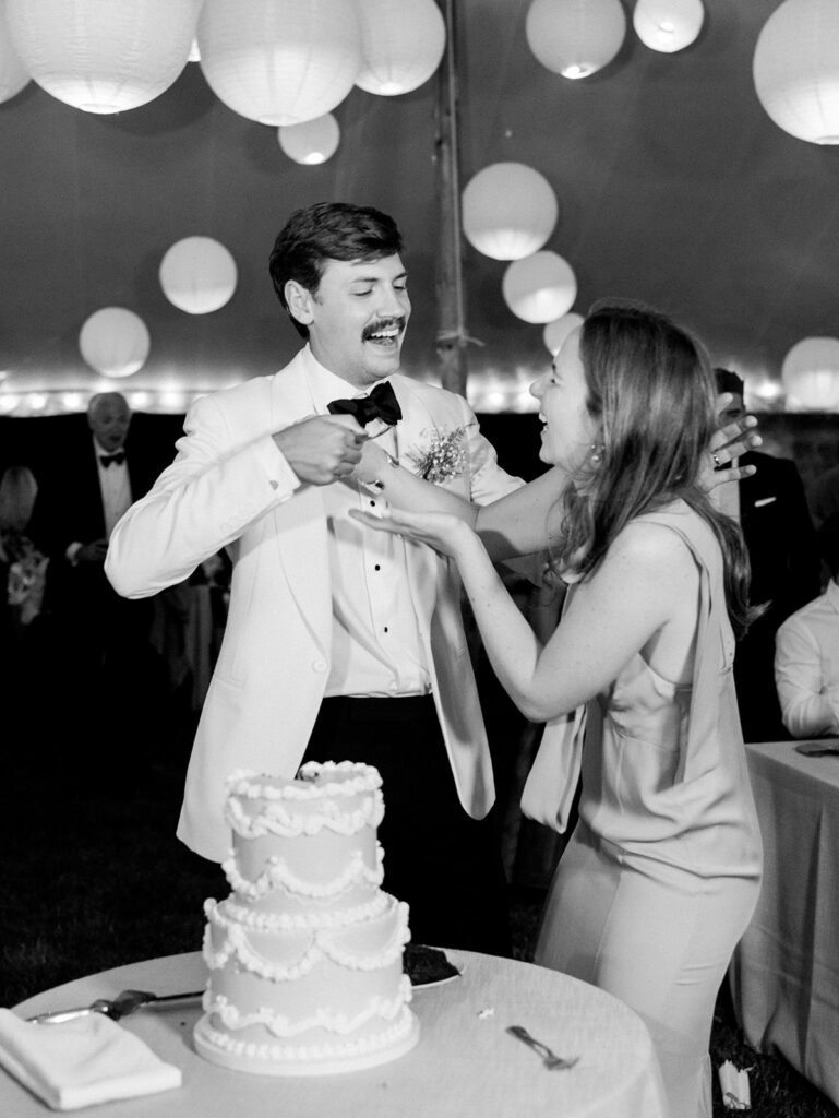 The groom feeding the bride cake during their cake cutting at their Daly and William