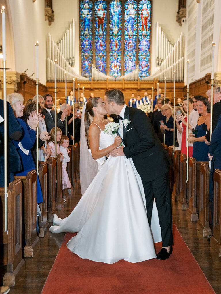 First kiss in the aisle of the church.