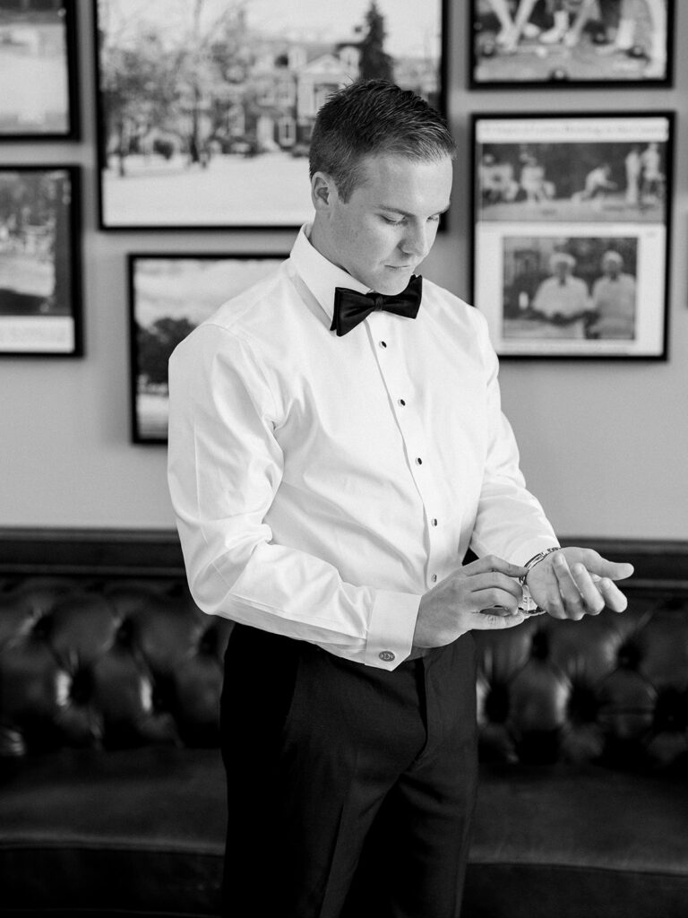 Groom getting ready and adjusting his cufflinks.