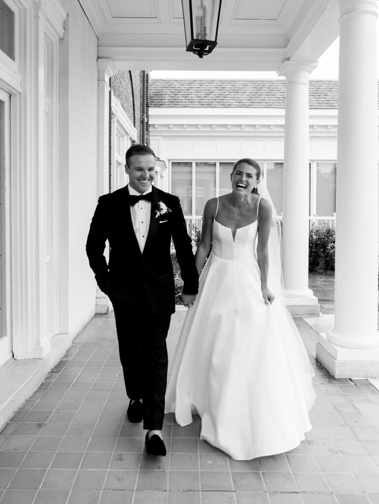 Bride and groom walking toward the camera in black and white at their Coveleigh-Club-Wedding.