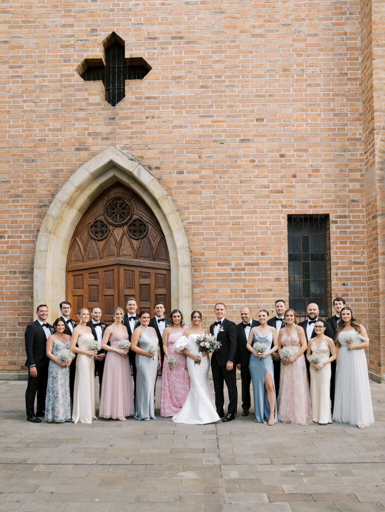 Full wedding party portrait in front of the church at their Colombia Wedding.
