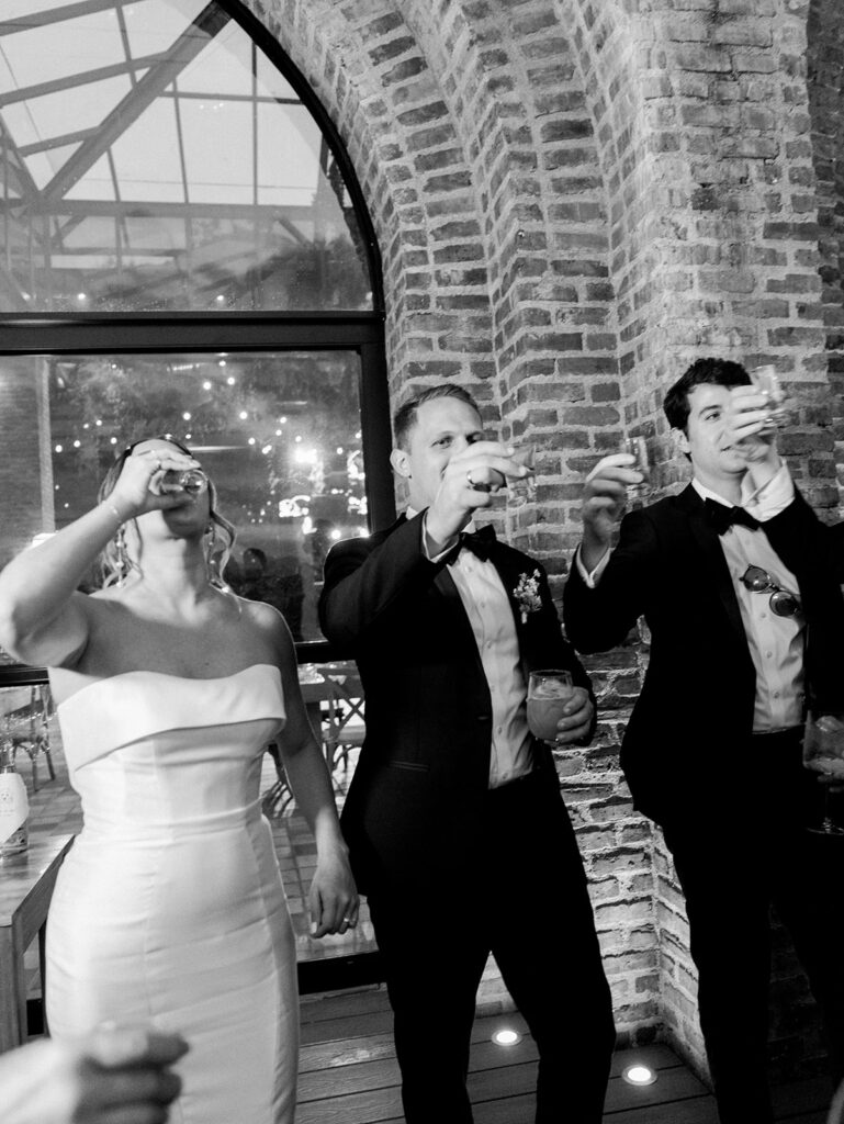 Taking a shot of alcohol at their Colombia Wedding.