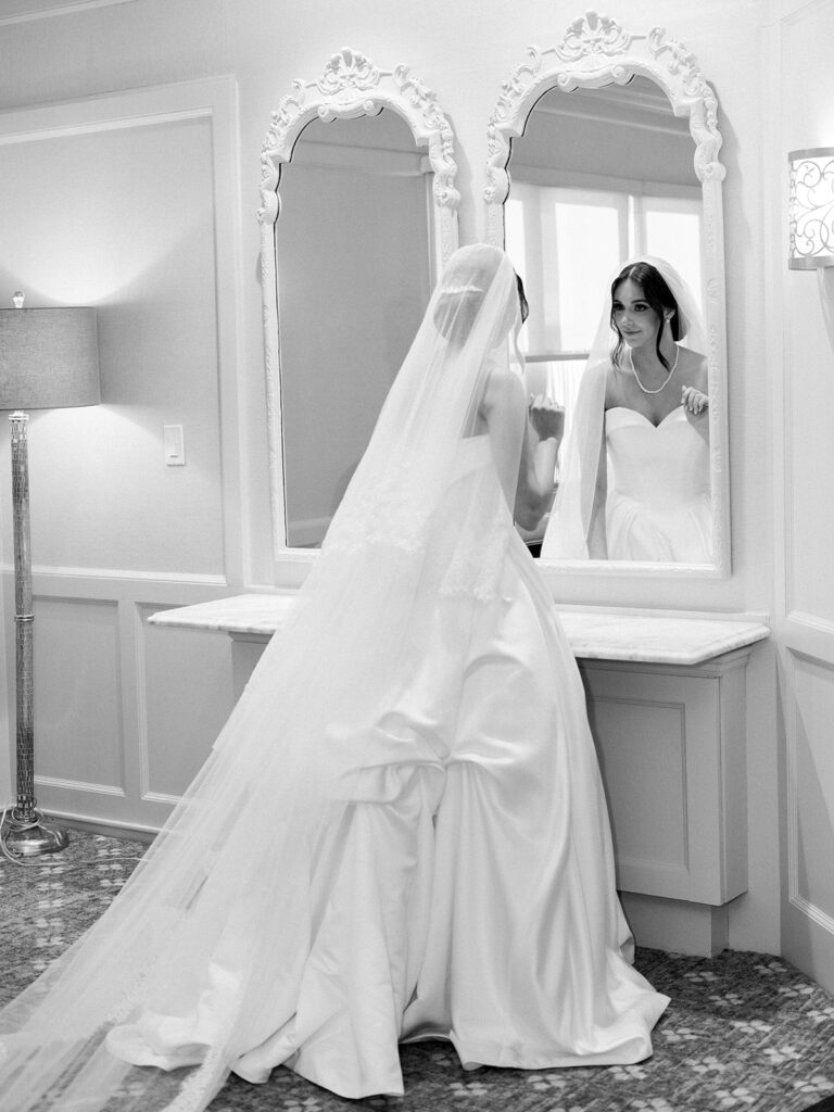 The bride looking in the mirror one more time before the ceremony.