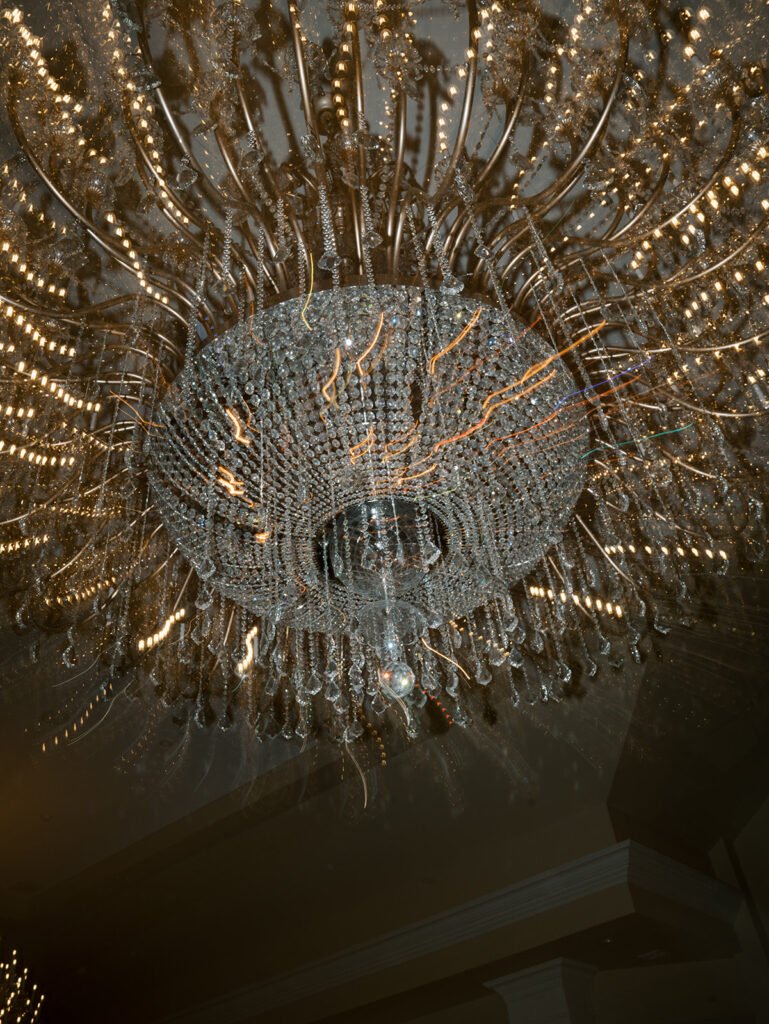 A detail photo of the chandelier at their wedding reception.