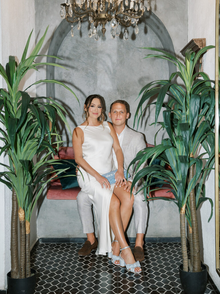 Bride and groom sit for a portrait during their rehearsal dinner in Colombia.