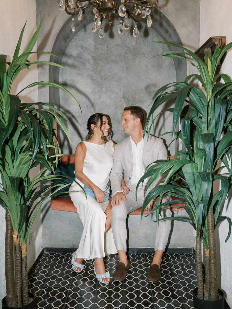 The bride and groom pose for a portrait in a little alcove at the restaurant.