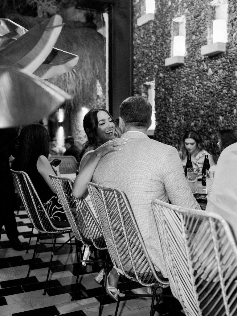 The bride and groom chatting at their table during dinner.