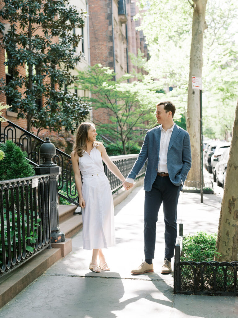 Bride and Groom holding hands looking at each other during their Greenwich Village Engagement Session