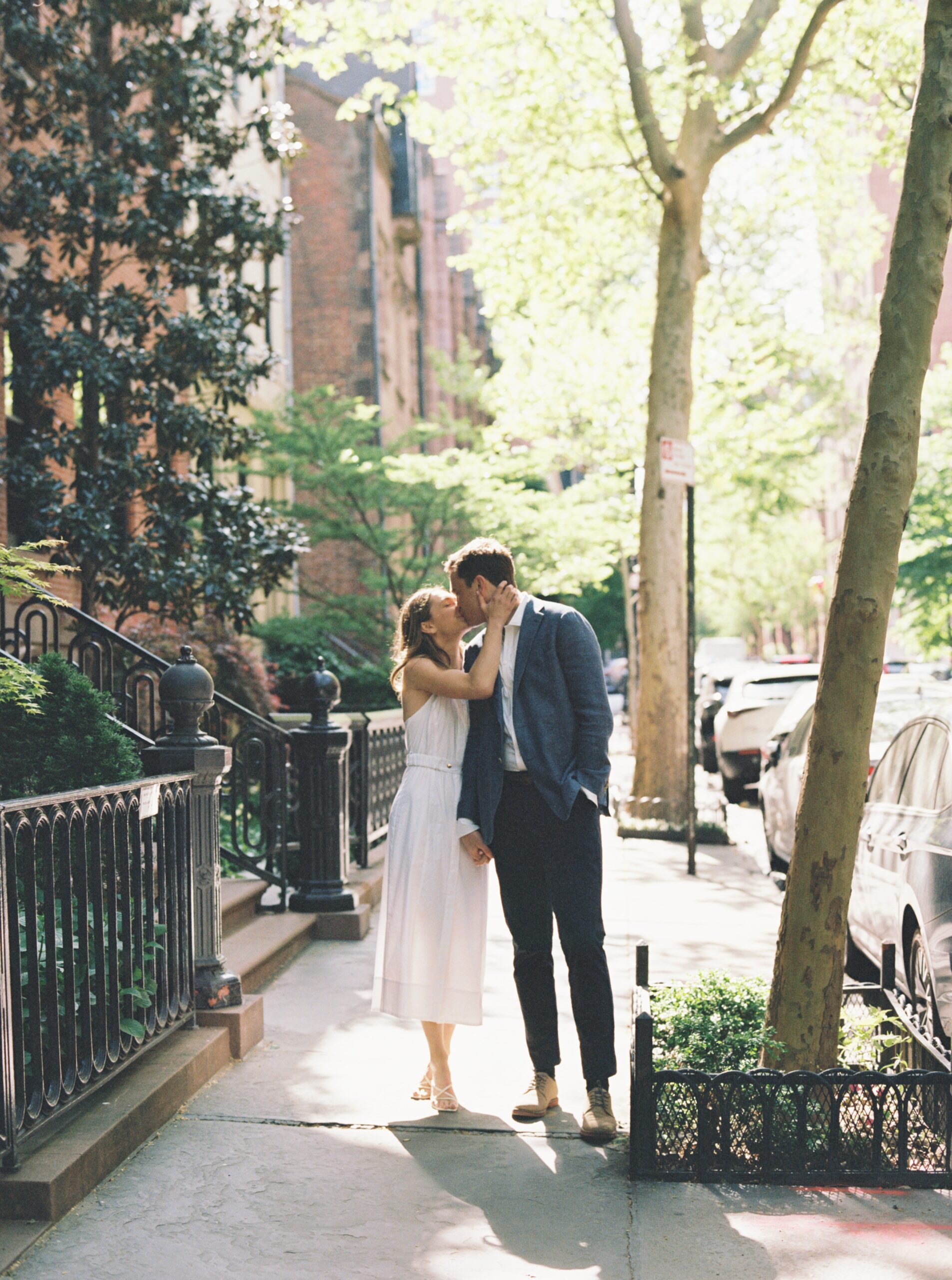 The couple kissing romantically on the street in Greenwich Village.