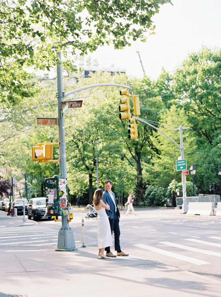 The couple is waiting to cross the street during their Greenwich Village Engagement Session