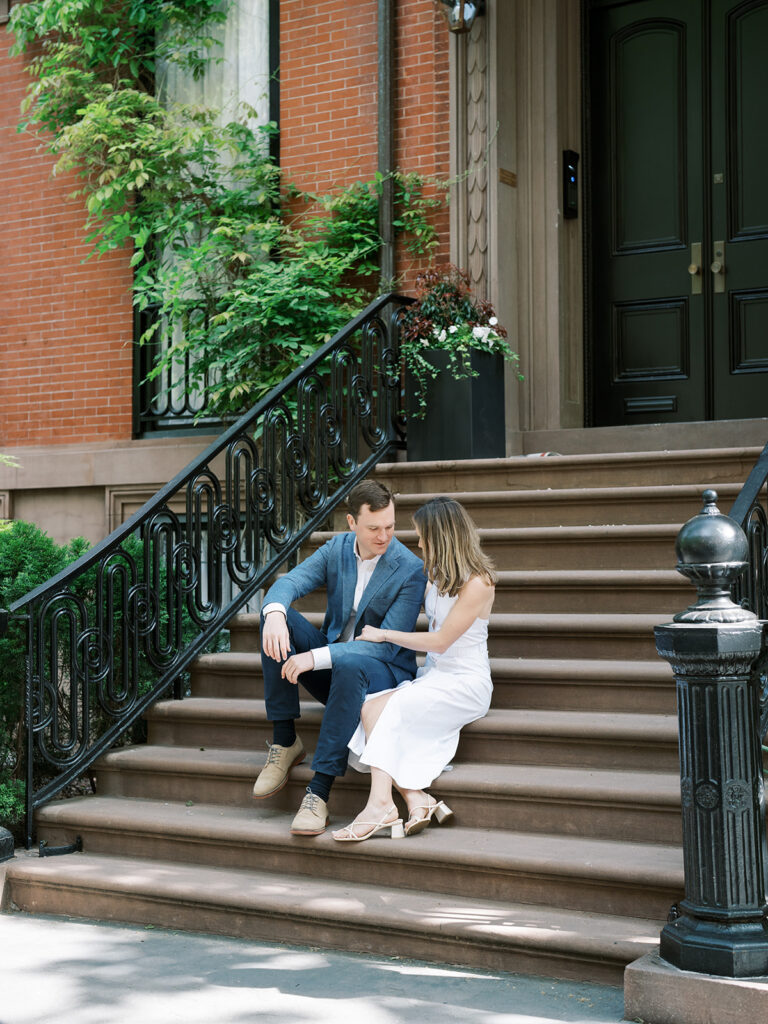 Bride and groom chatting on the steps during their Greenwich Village Engagement Session.