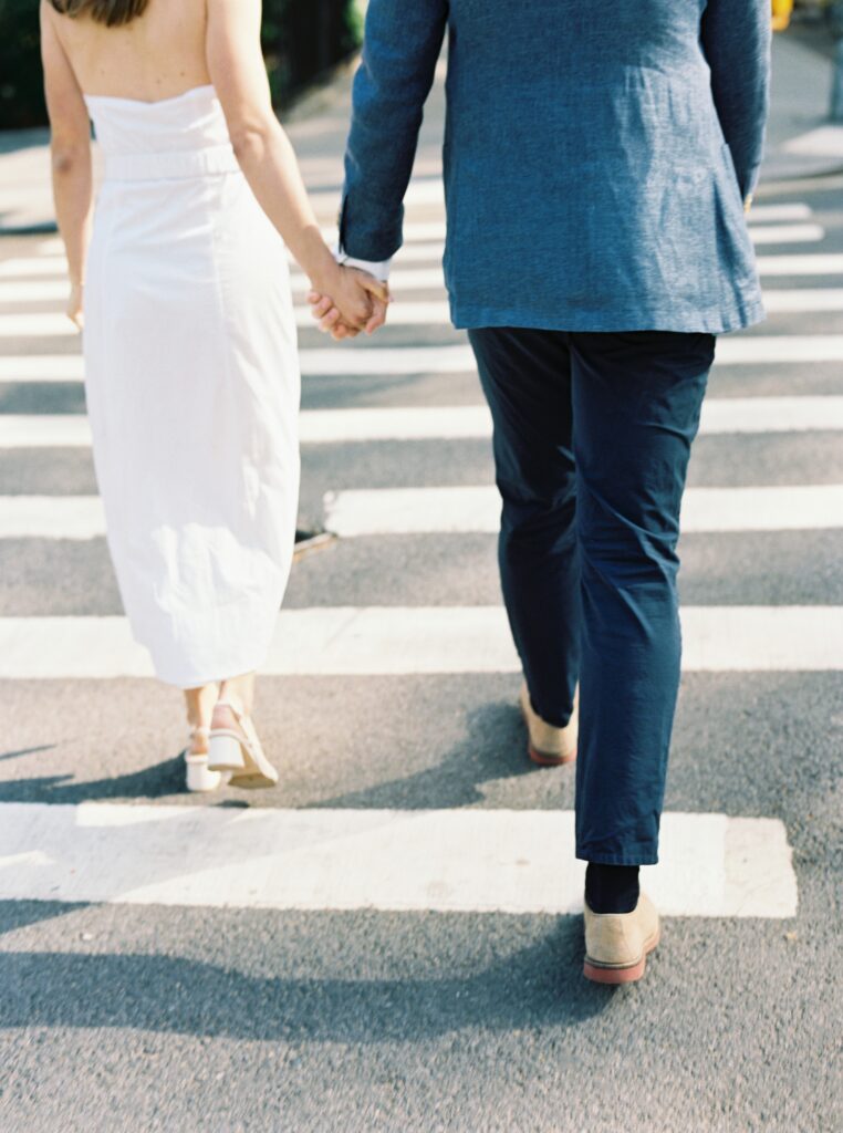 A close up shot of the couple crossing the street.