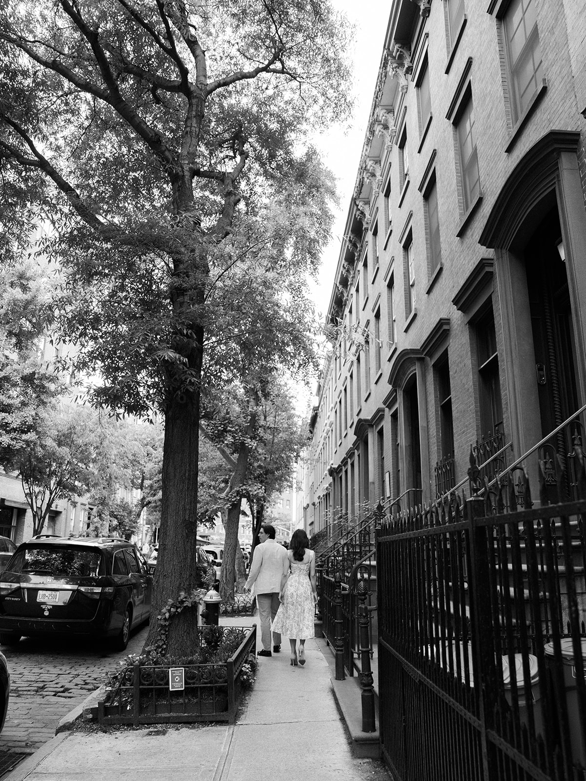 The couple walking down their street in the West Village.