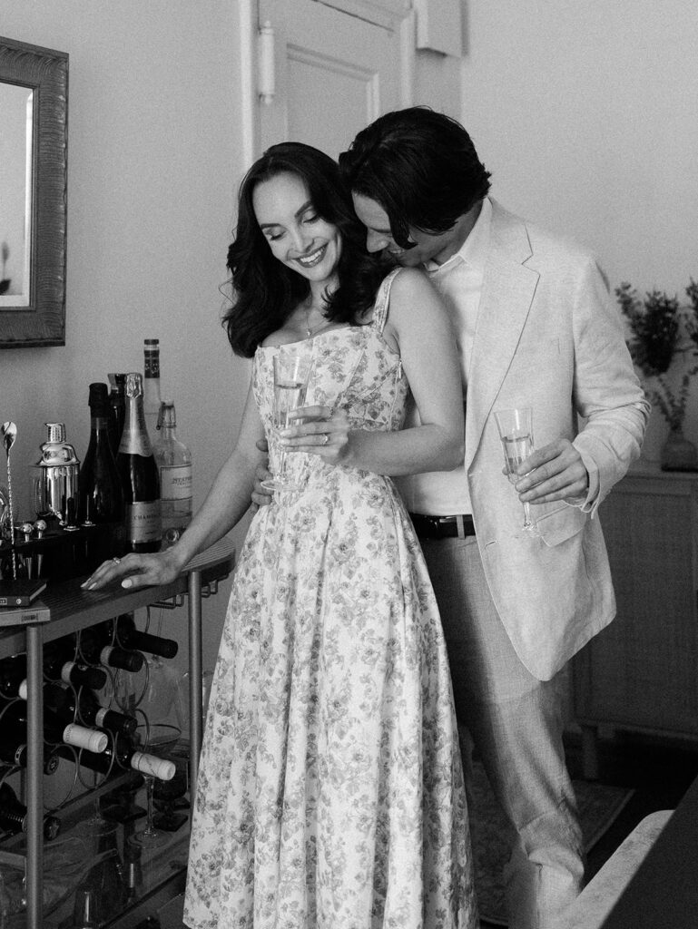 The groom giving a kiss on the neck to his future bride during their West Village Engagment photos.