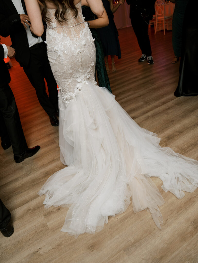 A detail shot of the bride's dress on the dance floor.