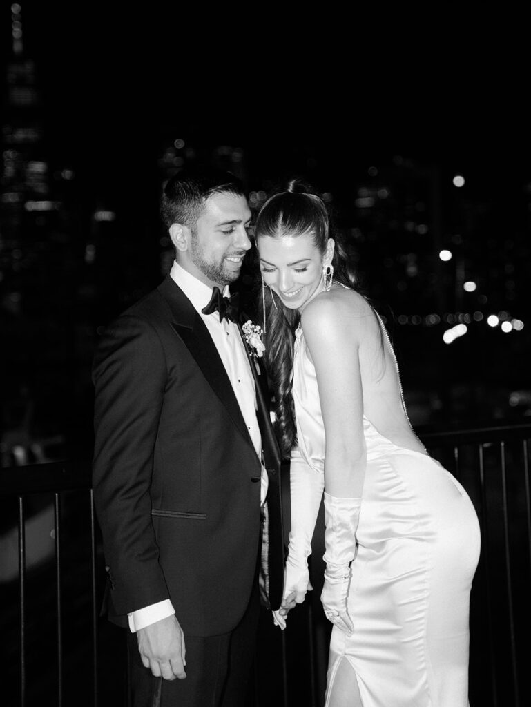 The bride and groom during night time portraits with Manhattan in the background.