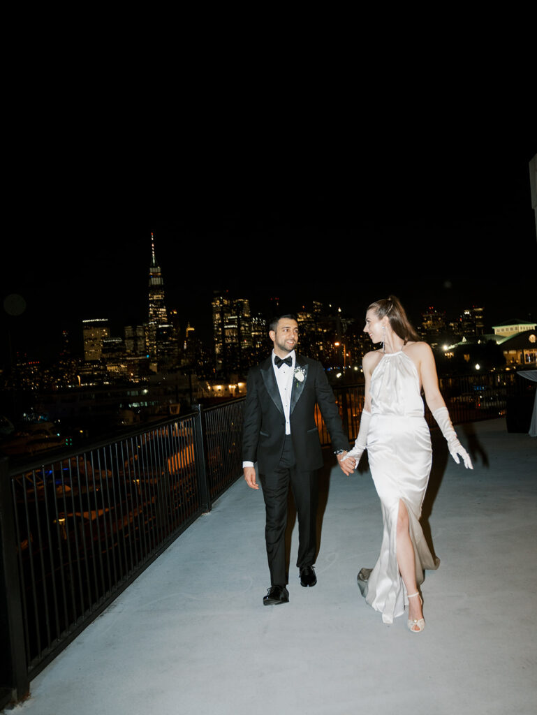 The bride and groom during night time portraits with Manhattan in the background.