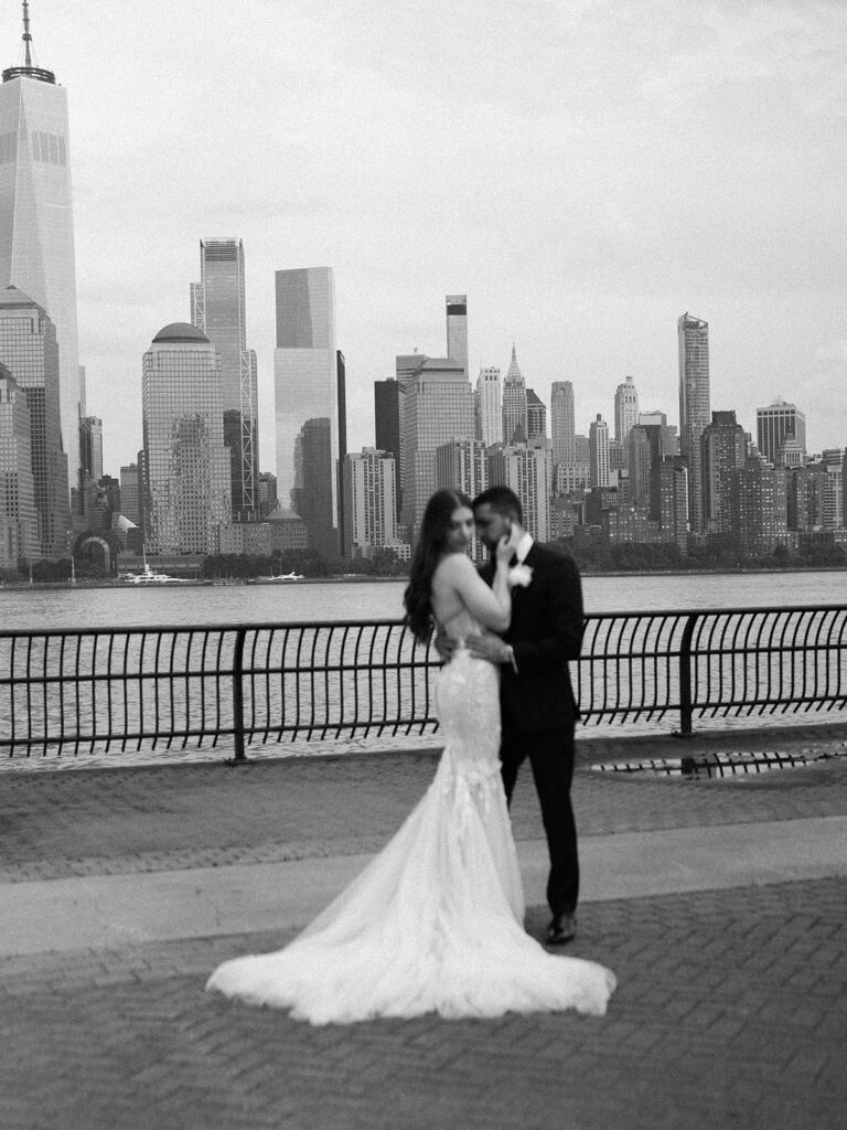 The bride and groom pausing for a portrait with the skyline in focus.