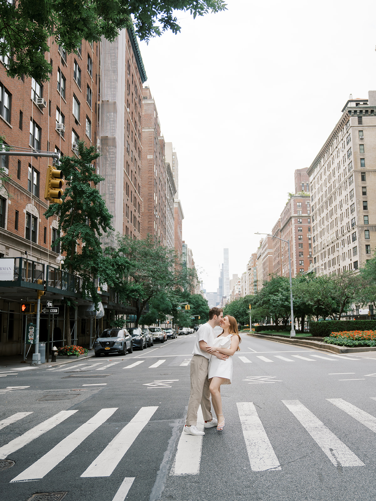sharing a kiss in the street during their upper east side engagement shoot