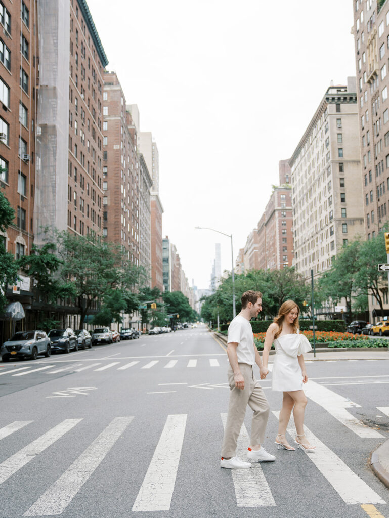 laughing as they finish crossing the street