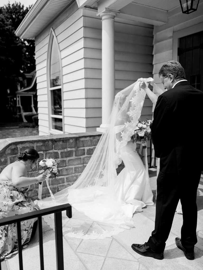 Bride arriving at church and her mother is helping with her veil