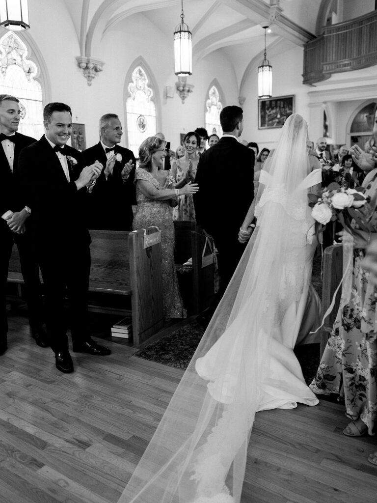 Fun view of the bride and groom from behind as they exit the church