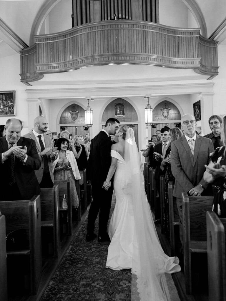 Aisle kiss by the bride and groom