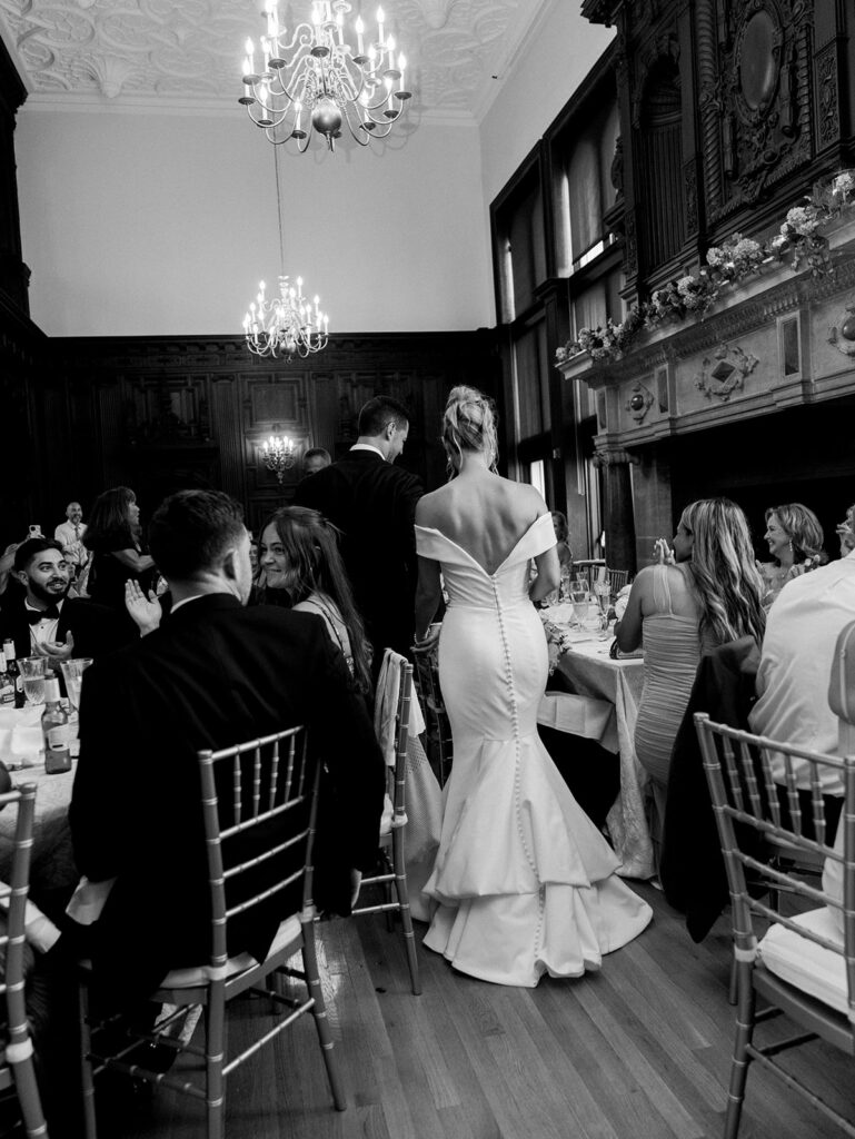 Bride and groom walking into their reception